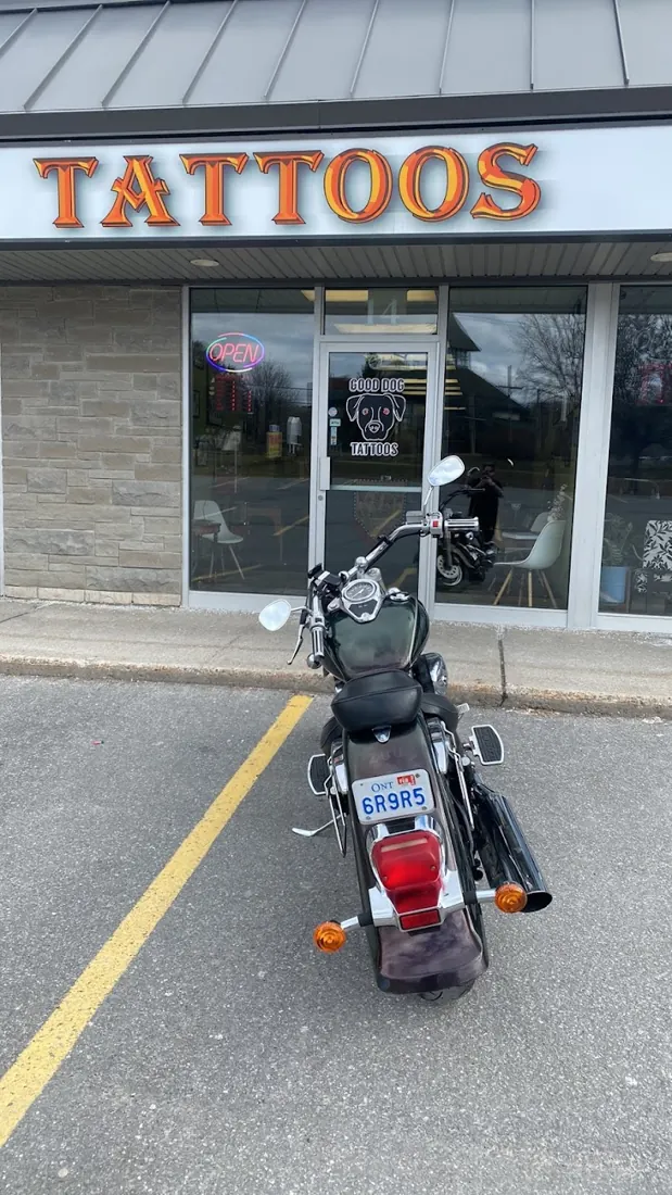 Good Dog Tattoos storefront on Hazeldean Road with a TATTOOS sign and a motorcycle parked out front